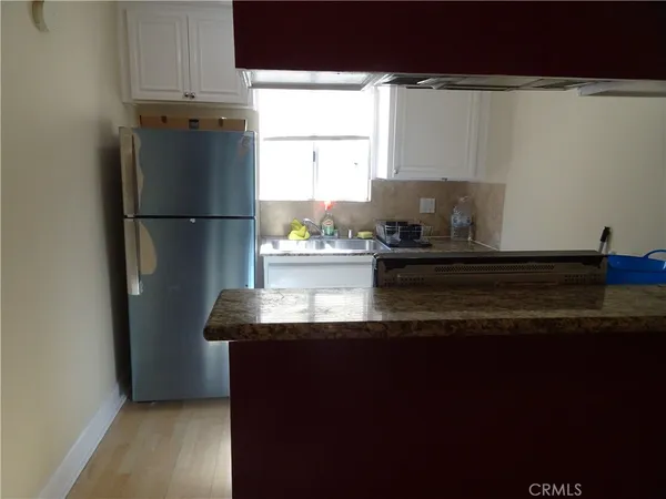 a kitchen with kitchen island a sink appliances and cabinets