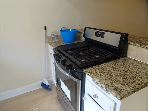a stove top oven sitting inside of a kitchen