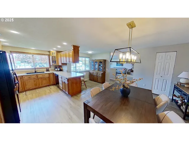a living room with stainless steel appliances kitchen island granite countertop furniture and a view of kitchen