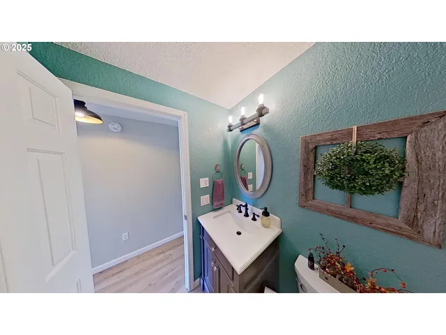 a bathroom with a sink mirror and vanity