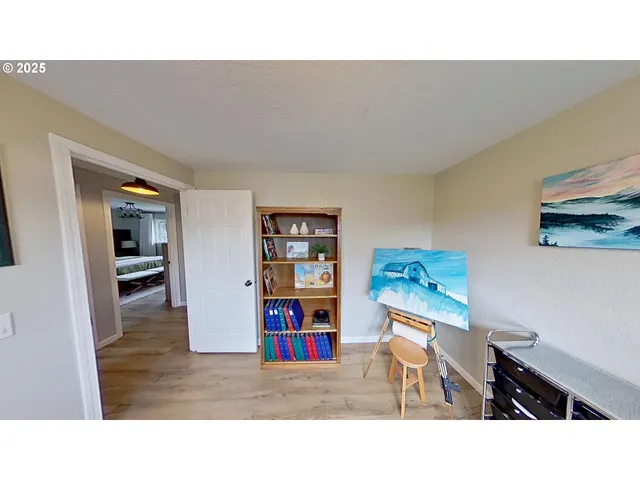 a living room with a couch and bookshelf