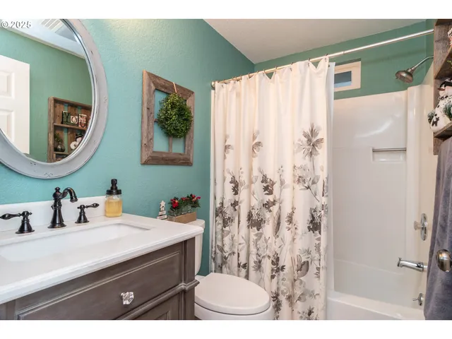 a bathroom with a sink vanity mirror and toilet