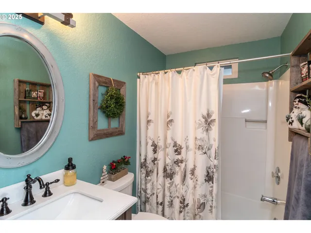 a bathroom with a sink a mirror and a shower