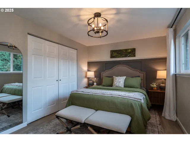 a bedroom with a bed a couch and a window