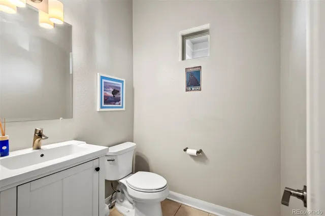 a bathroom with a sink mirror and toilet