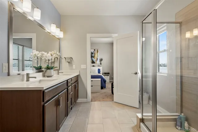 a spacious bathroom with a double vanity sink a and mirror