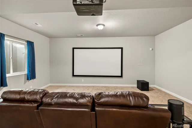 a room with gym equipment and a flat screen tv