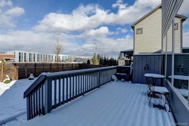 a view of a balcony with two chairs and a wooden fence