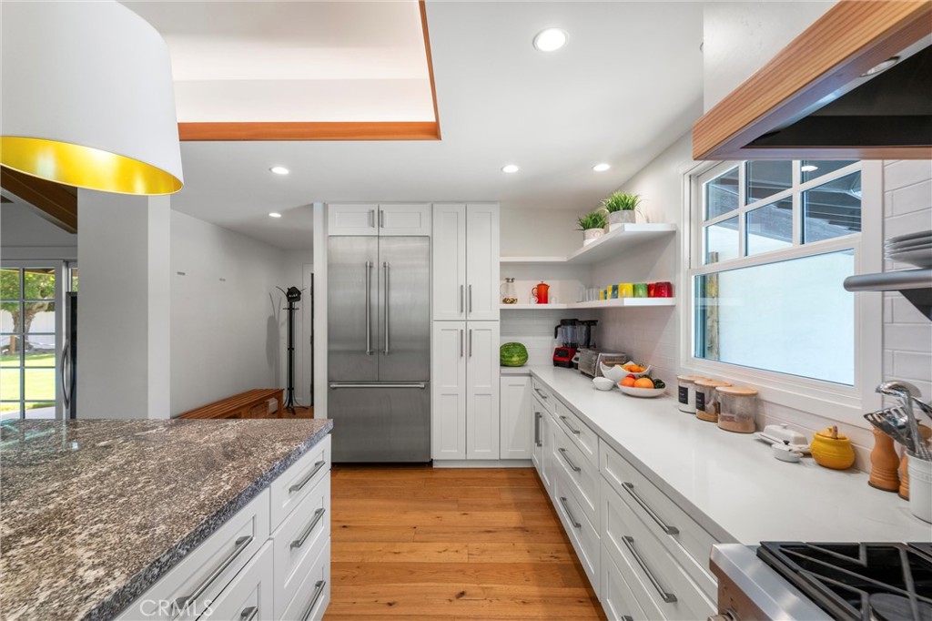 7337 La Soldadera Rancho Santa Fe, CA 92067 - Photo 10 of 60 a kitchen with refrigerator and cabinets