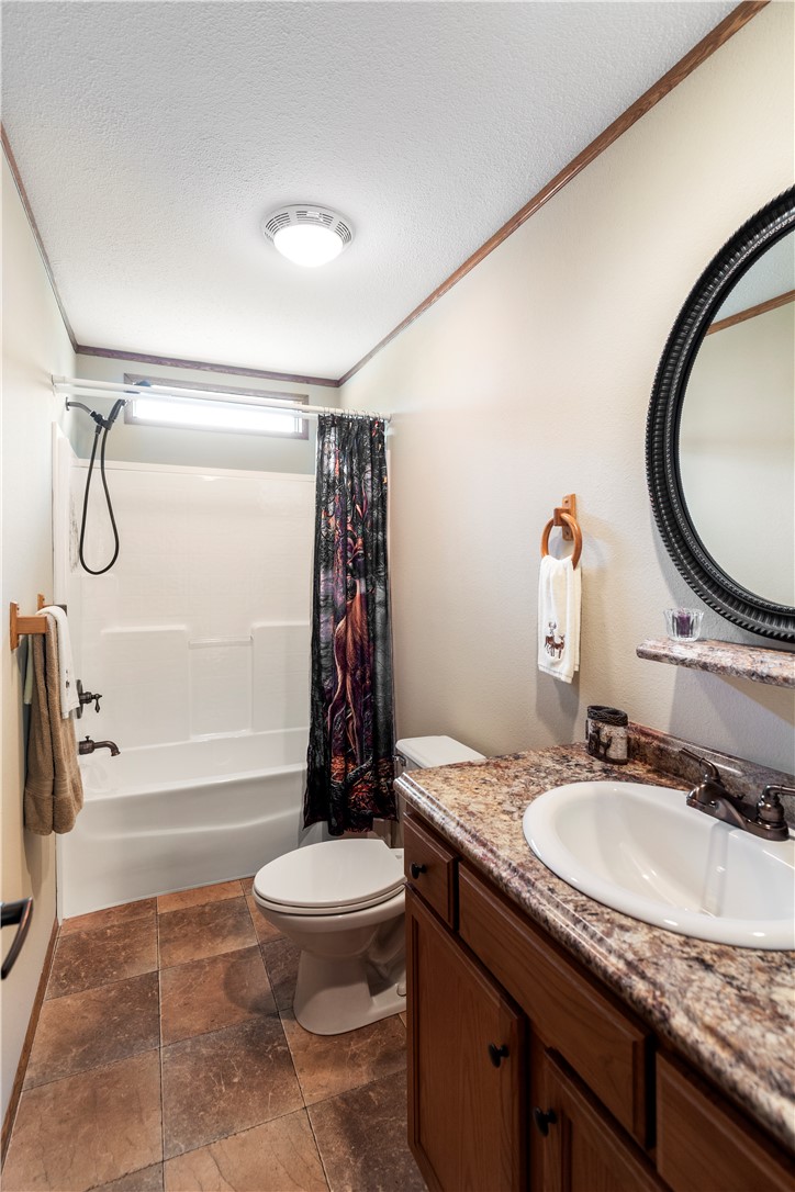 265 A State Rd S-37-141 Westminster, SC 29693 - Photo 26 of 33 A well-appointed bathroom features a practical shower-over-tub combination and a vanity with ample counter space.