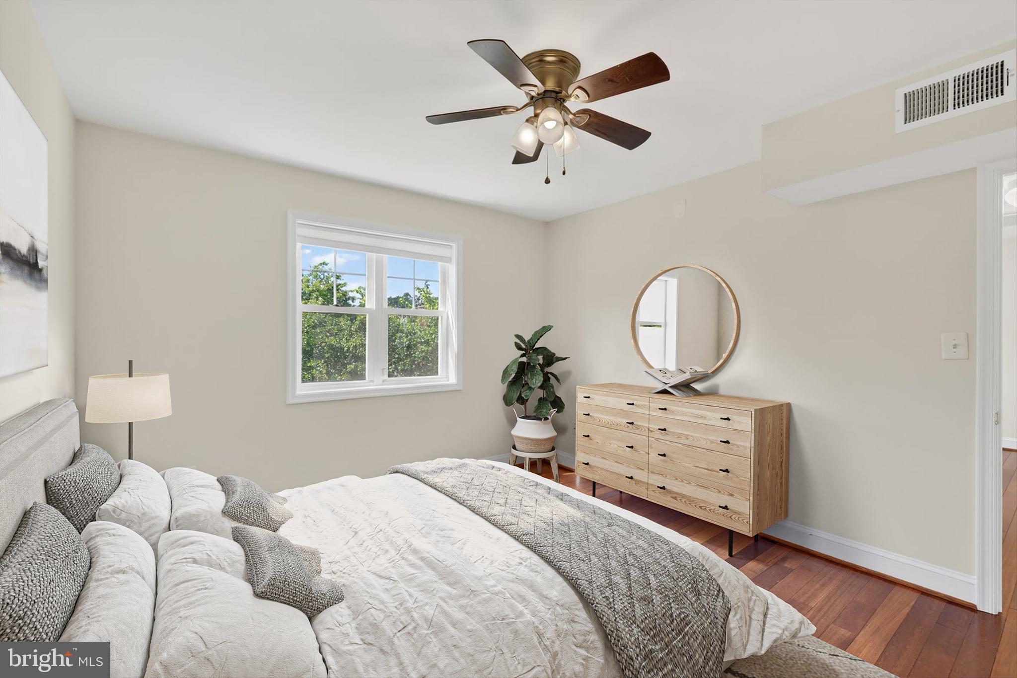 3868 9th Street Southeast, Unit 301 Washington, DC 20032 - Photo 12 of 16 a bedroom with a bed chandelier and a window