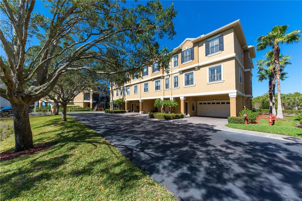 592 Bella Loop Dunedin, FL 34698 - Photo 2 of 25 a view of a house with a yard and tree s