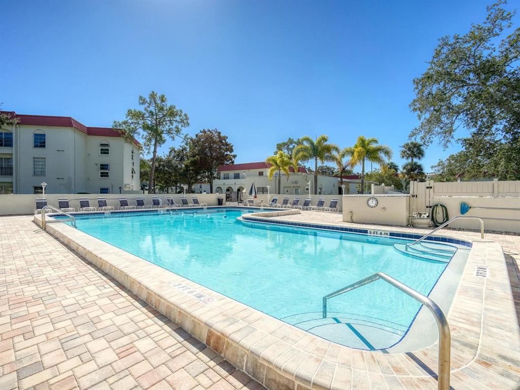592 Bella Loop Dunedin, FL 34698 - Photo 23 of 25 a view of a swimming pool with a lounge chairs