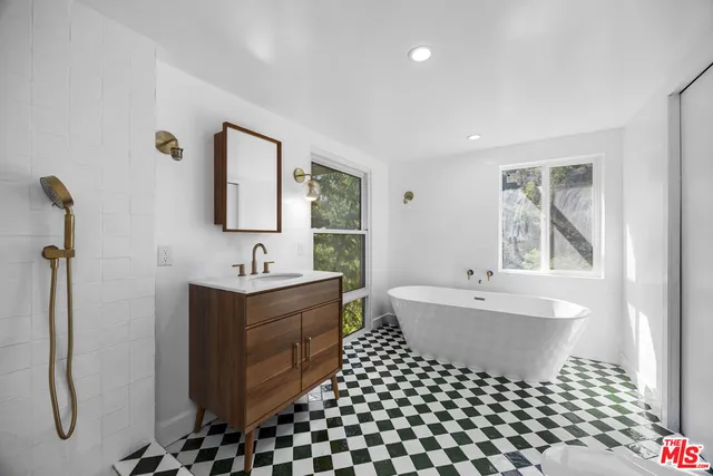 a bathroom with a sink toilet and mirror