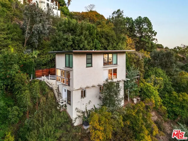 front view of a house with a tree