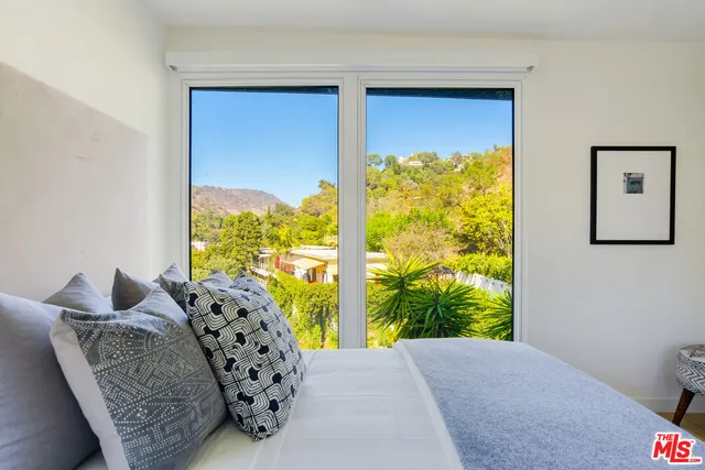 a bed room with a bed and a window