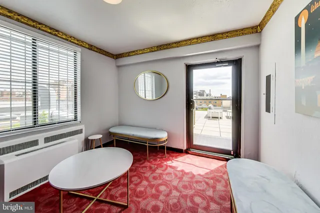 a living room with furniture a window and a sink