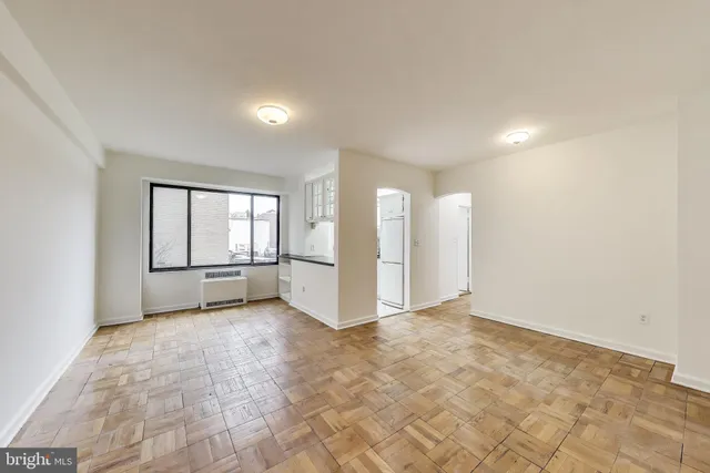 an empty room with windows and closet