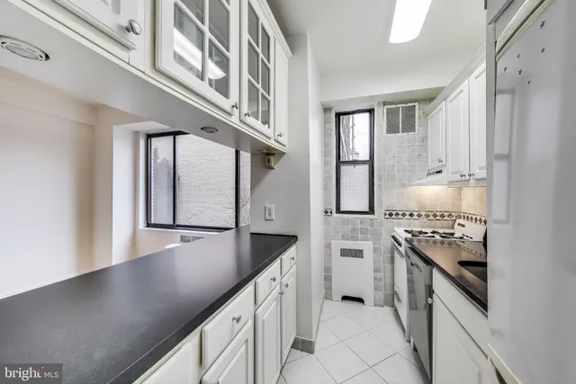 a kitchen with stainless steel appliances granite countertop a sink and stove
