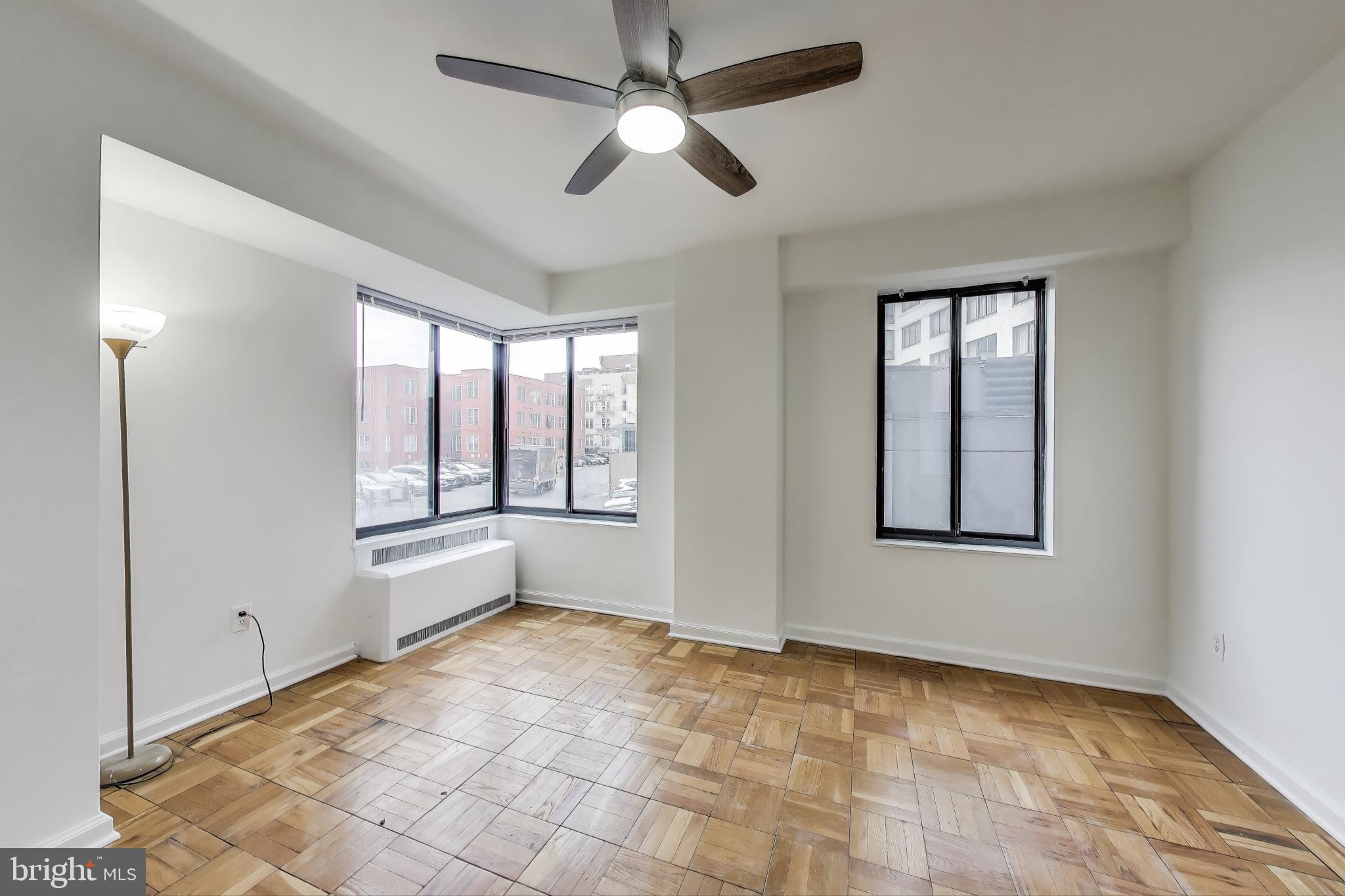 1 Scott Circle Northwest, Unit 121 Washington, DC 20036 - Photo 9 of 30 a view of an empty room with window and chandelier fan