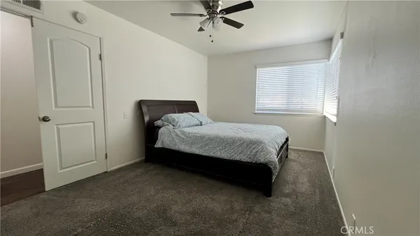 a bedroom with a bed and window