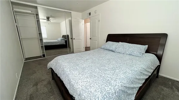 a bedroom with bed and window