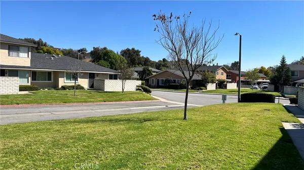 a house with pool in front of it