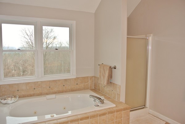 10 Osgood Road Sterling, MA 01564 - Photo 18 of 30 a white bath tub sitting next to a window
