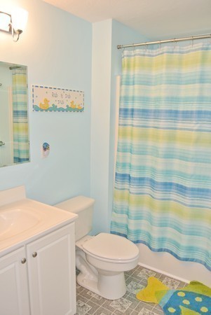 10 Osgood Road Sterling, MA 01564 - Photo 21 of 30 a bathroom with a sink a toilet and shower curtain