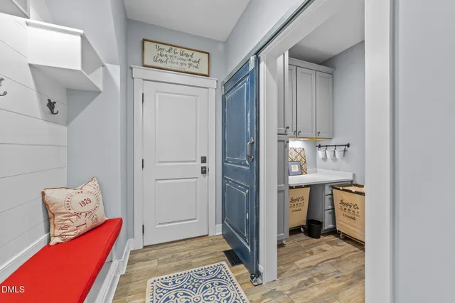 a bedroom with a large bed a chandelier and a window