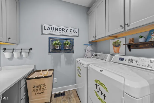 a spacious bedroom with a bed and a chandelier