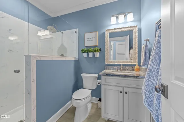 a bedroom with a large bed and a ceiling fan