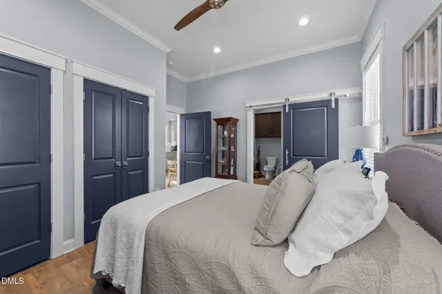 a bathroom with a granite countertop toilet a sink and a mirror