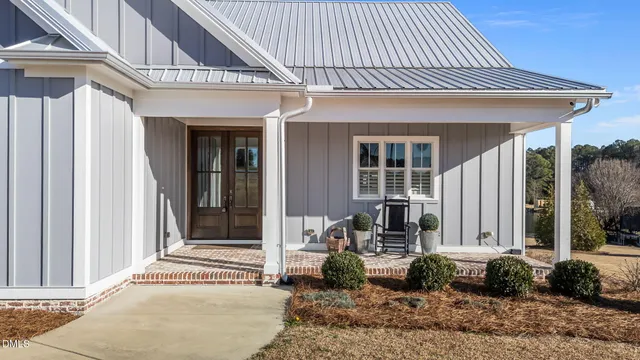 an aerial view of a house with outdoor space and lake view