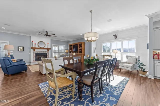 a living room with furniture kitchen view and a fireplace