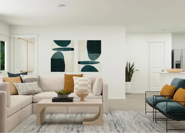 a living room with furniture and wooden floor