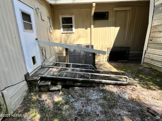 a living room with table chairs and a stove