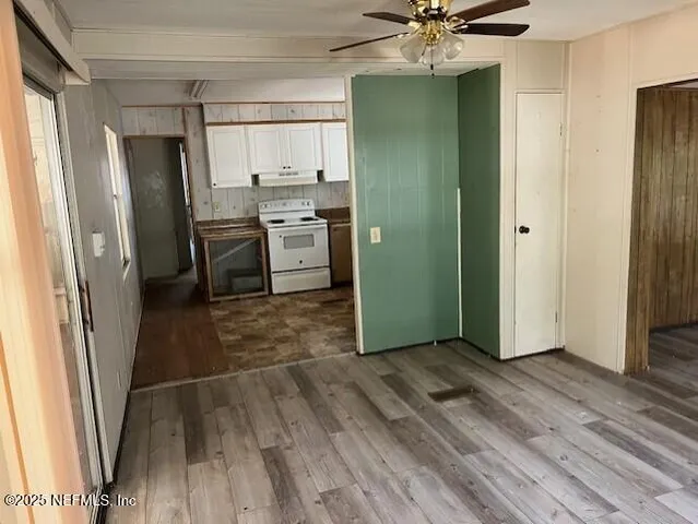 a kitchen with stainless steel appliances a refrigerator and a stove top oven