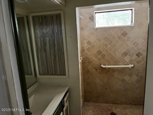 a bathroom with a shower and a sink