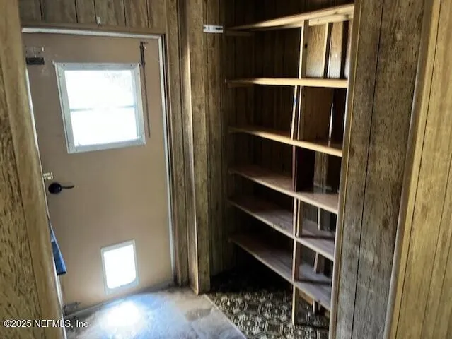 a view of walk in closet with empty racks