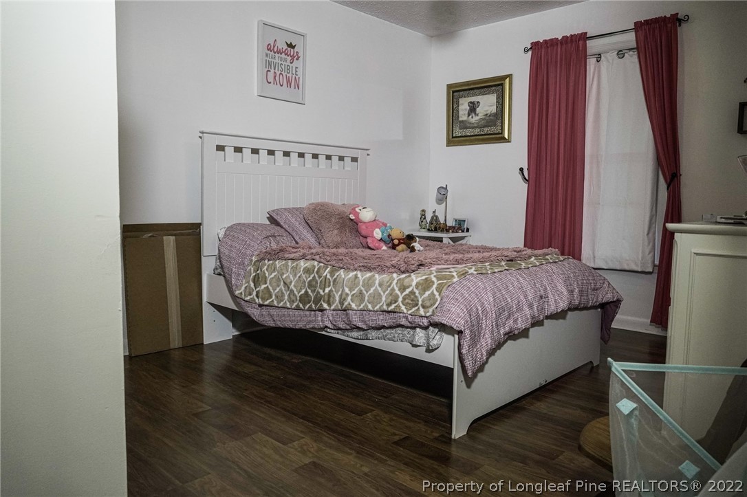 720 Riyhad Road Fayetteville, NC 28314 - Photo 17 of 22 a bedroom with a bed lamp and a window