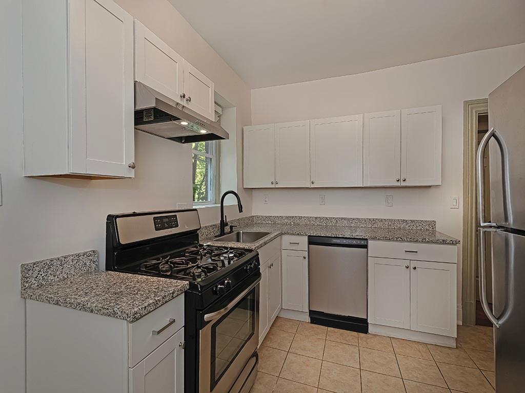 628 North Euclid Avenue, Unit 2 Pittsburgh, PA 15206 - Photo 13 of 27 a kitchen with stainless steel appliances granite countertop a stove a sink and a refrigerator