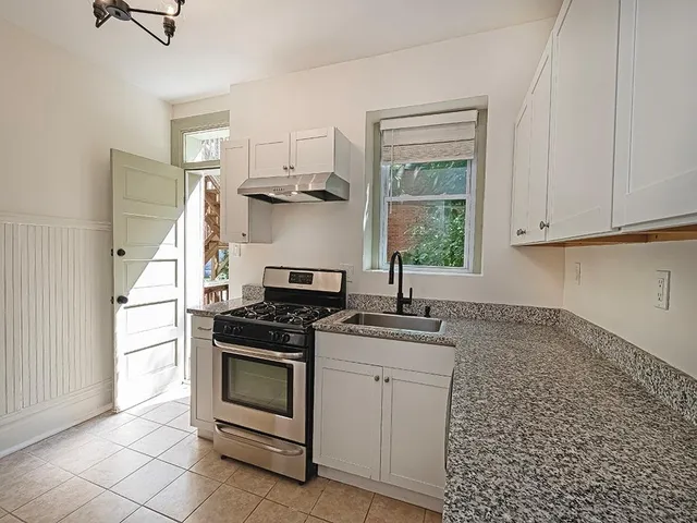 a kitchen with a stove and a sink