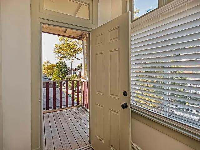 a view of a balcony with wooden floor