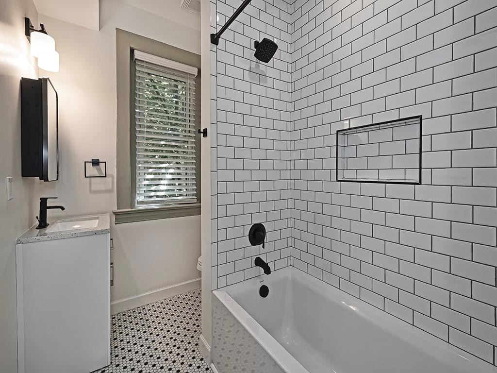 628 North Euclid Avenue, Unit 2 Pittsburgh, PA 15206 - Photo 18 of 27 a bathroom with a bathtub and next to a window