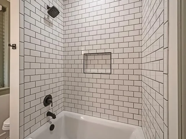 a bathroom with a bathtub and shower