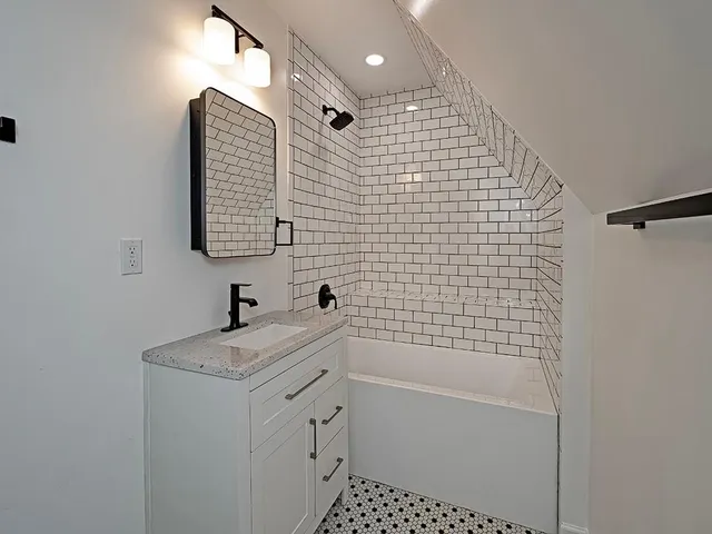 a bathroom with a shower toilet and sink