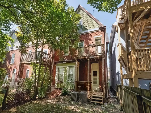a view of a house with brick walls