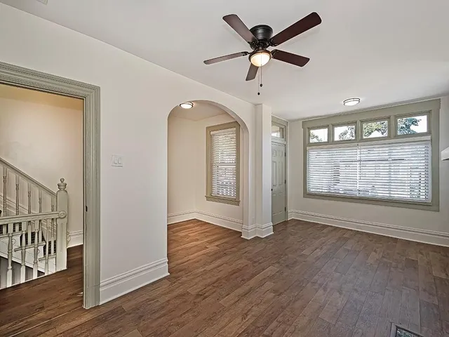wooden floor in an empty room with a window