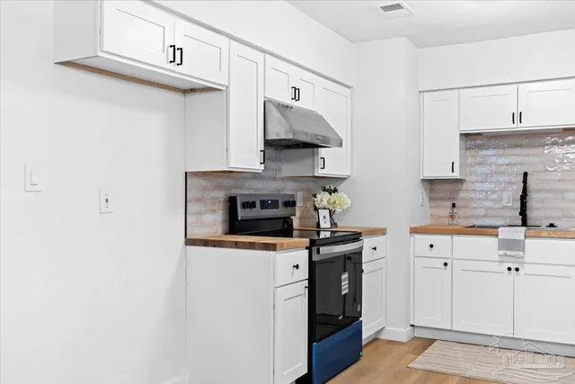 a kitchen with stainless steel appliances a stove and a refrigerator